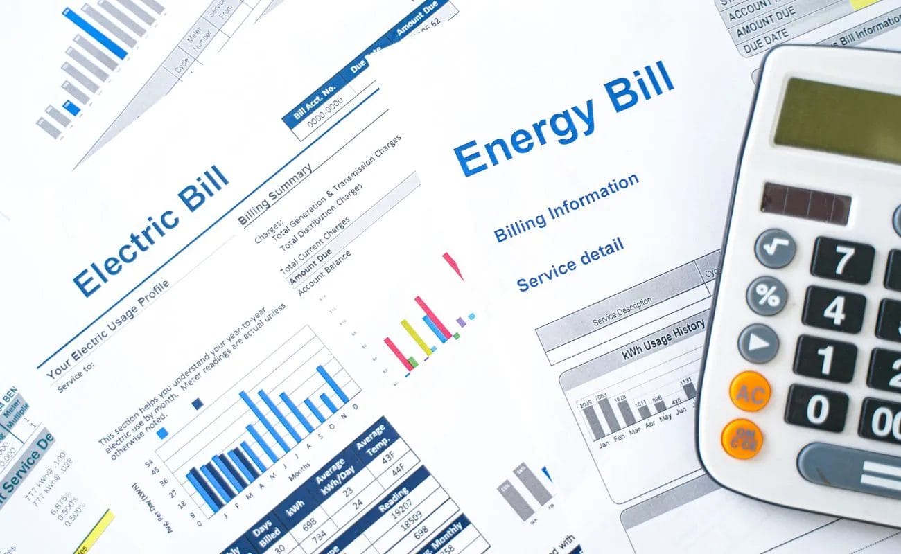 Energy bill with charts, graphs, and a calculator, relevant to solar panel installation costs.