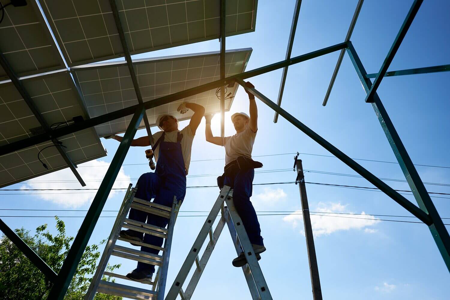 Solar panel installation: Two workers installing solar panels on a sunny day.