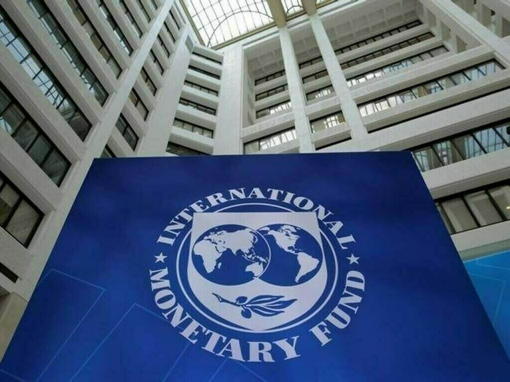 International Monetary Fund (IMF) logo against a building backdrop.